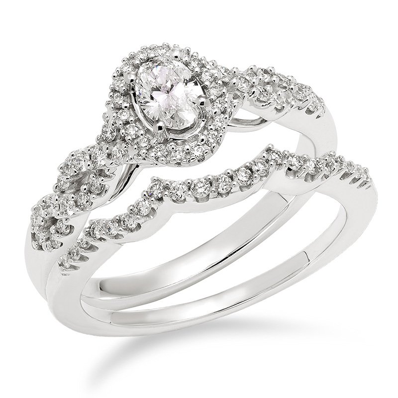 White gold and diamond oval halo bridal set